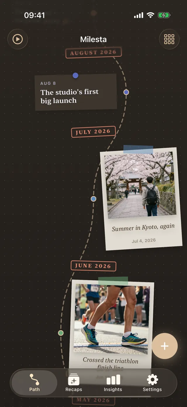 The Scrapbook design in dark mode: taped polaroids and pinned notes along a pencilled trail, with stamped month labels.